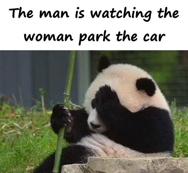 The man is watching the woman park the car